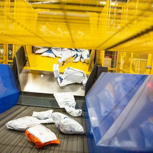 Система разгрузки для посылок - VANDERLANDE - для грузовика / для поддонов / с арматурным каркасом